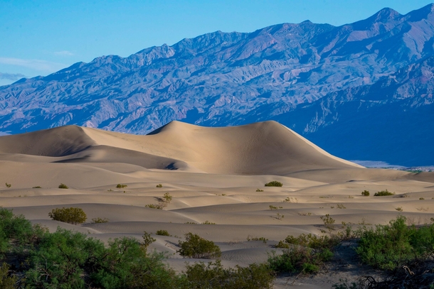 I used a telephoto lens to compress the distance between the Mesquite sand dunes and the mountains surrounding Death Valley 