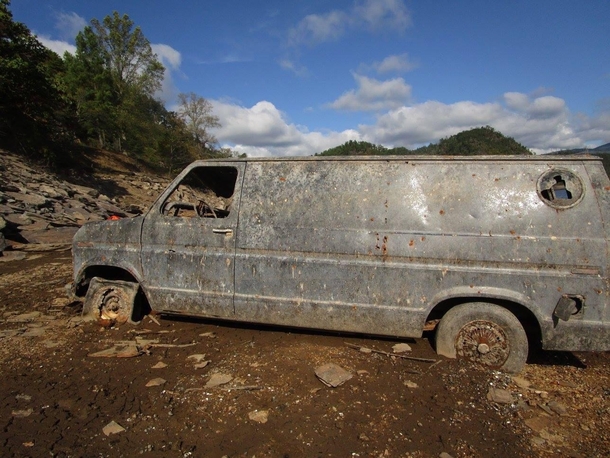 I waded through several inches of mud in order to photograph this beauty Typically submerged by Chilhowee Lake this van is visible when the lake is drained I climbed up on the hood and peeked through the windows discovering the interior was filled with we