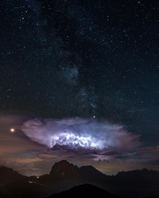 I was just trying to capture the milky way but witnessed this spectacular storm as well over Langkofel in The Dolomites 