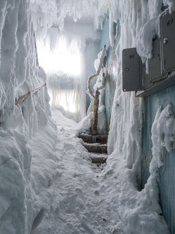 Ice and snow invade a stairwell in an abandoned building in Vorkuta Russia - 