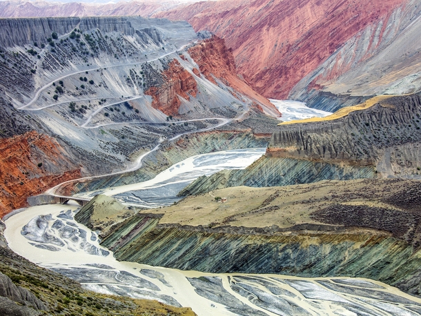 In the northern slopes of the Tian Shan Mountains in China a river carves its way through a canyon The layers are eroded by wind and water transforming the landscape into these colorful terraces  Photo by Tugo Cheng