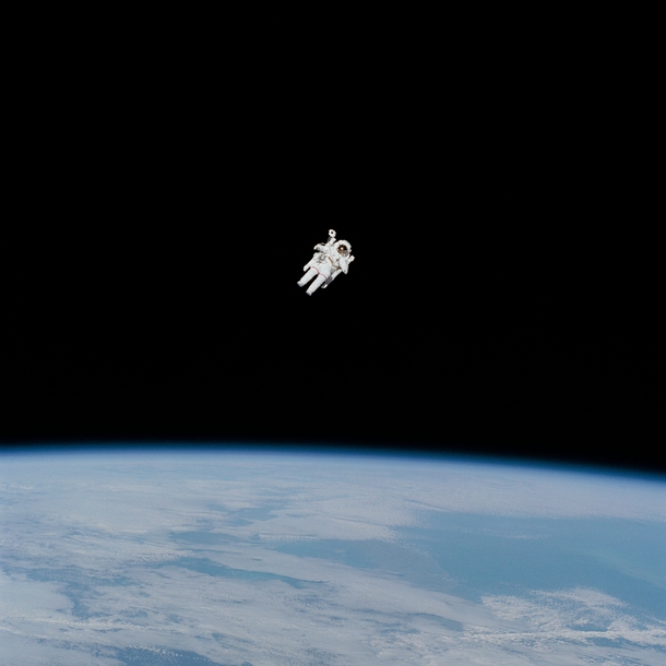 In this Feb   photograph of the first untethered spacewalk NASA astronaut Bruce McCandless is in the midst of the first field tryout of a nitrogen-propelled backpack device called the Manned Maneuvering Unit MMU 