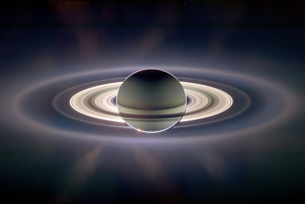 In this imageCassini captured Saturns night side that is partly lit by the light reflected from its ring system E-ringcreated by the ice-fountains of Enceladus amp the outermost ring visible aboveCreditNASAESAJPLSSI Cassini imaging team