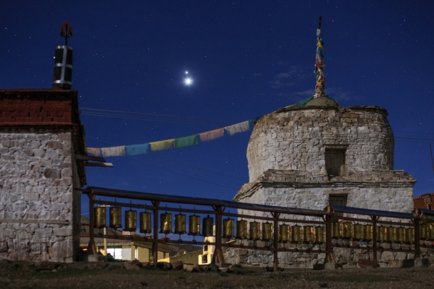 Jupiter and Venus the brighter one shine above a Buddhist Stupa in Yamdrok Lake Tibet