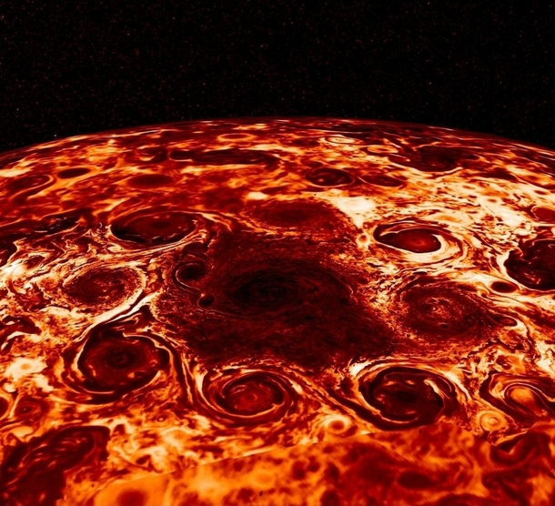 Jupiters North Pole in infrared showing a cluster of  enormous cyclonic storms circling a central region