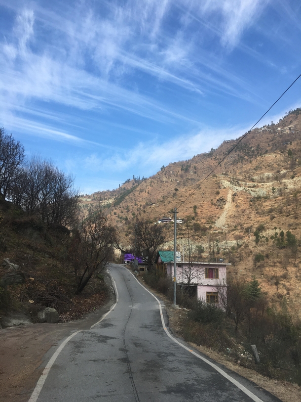 Just a bright sunny day with several patterns of cloud formations changing simultaneously after every two to three turns on those beautiful roads Location- Great Himalayan National Park UNESCO World Heritage Site Tirthan Valley Himachal Pradesh INDIA 