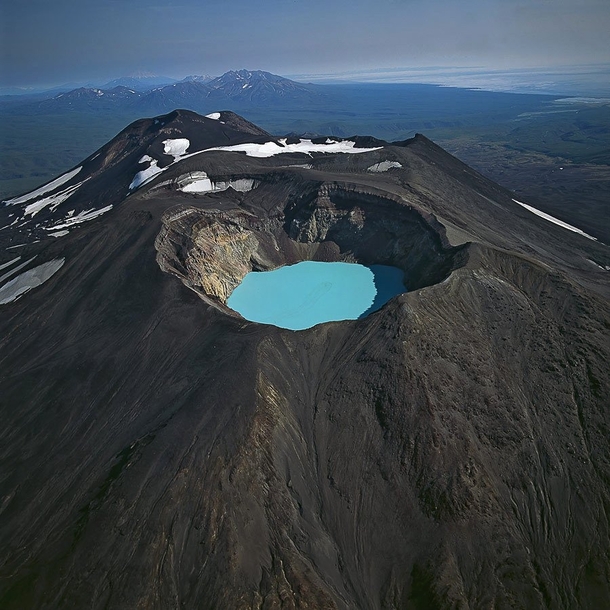 Karymsky Lake is a crater lake located in the Karymsky volcano in Russia