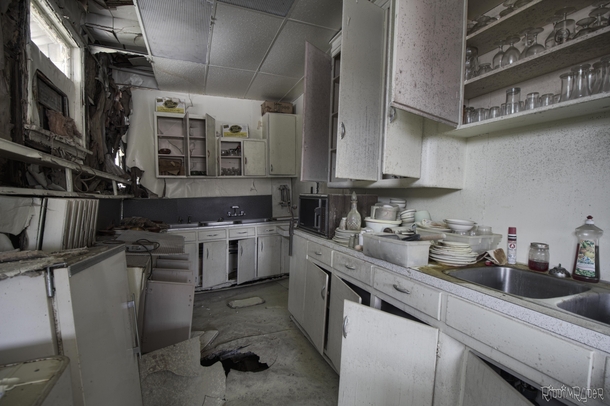 Kitchen Collapsing into itself inside an Abandoned Restaurant with everything left behind 