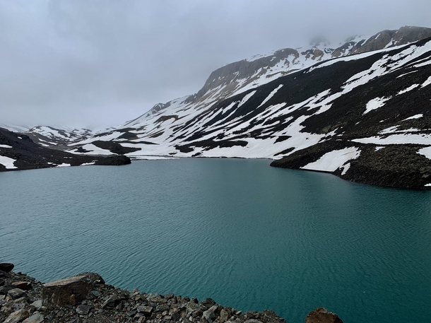 Lake beside snow capped mountains in Suryatal Himachal Pradesh 