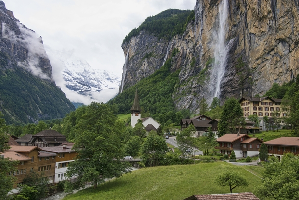 Lauterbrunnen Switzerland with Staubbach Falls on the right and the Lauterbrunnen Wall in the distance 