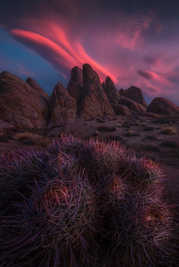 Lenticular clouds at sunrise over the granite formations of Californias Alabama Hills 