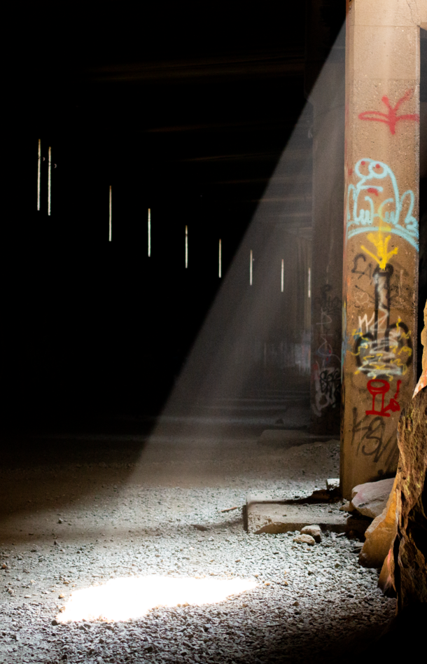 Light filtering into an old abandoned railway tunnel