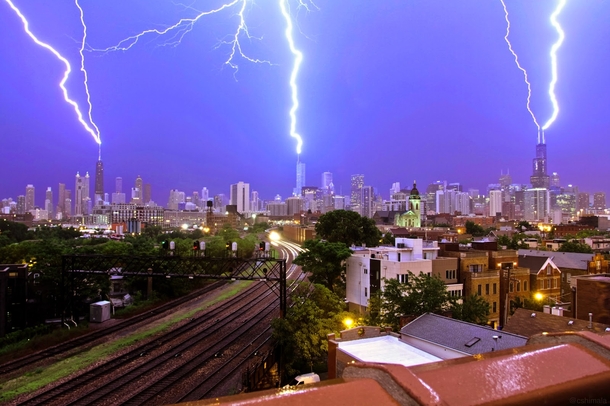 Lightning on the Chicago skyline with a great rail line shot x-post from rpics 