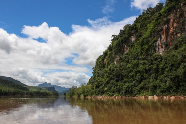 Limestone mountains and blue skies on the river in Nong Khiaw Laos 