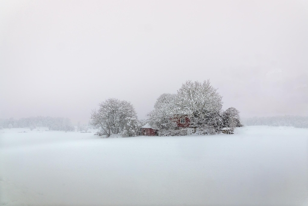 Lonely house in a foggy winter landscape at sunset Sweden 