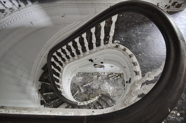 Looking Down A Gorgeous Staircase Inside an Abandoned Victorian Mansion 