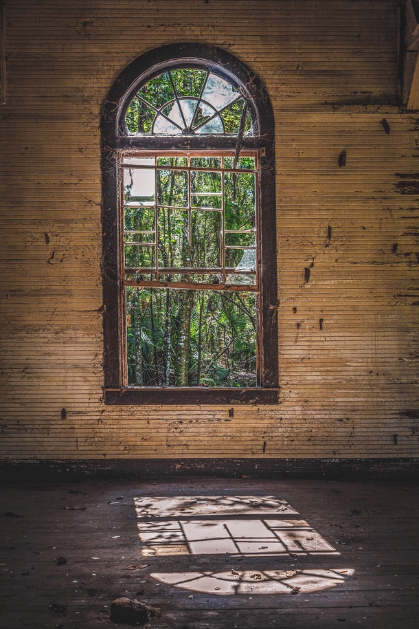 Looking through a window at an abandoned church in Florida OC