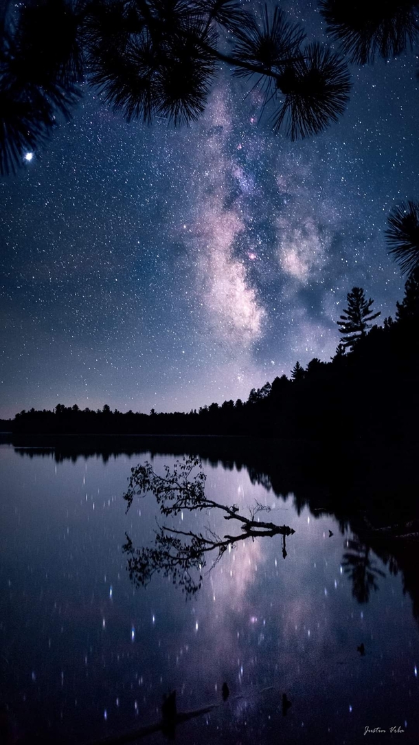 Looking up into our galaxy over the lake on a calm night near Drummond Wisconsin Photo by Justin Vrba 