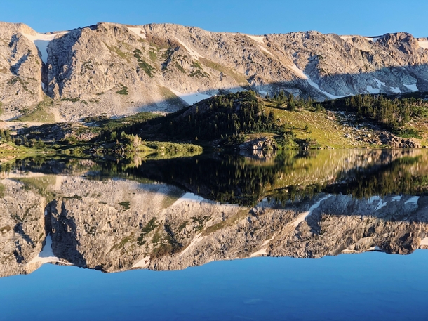 Medicine Bow Peak in the Snowy Range Mountains reflecting on Mirror Lake near Centennial Wyoming 