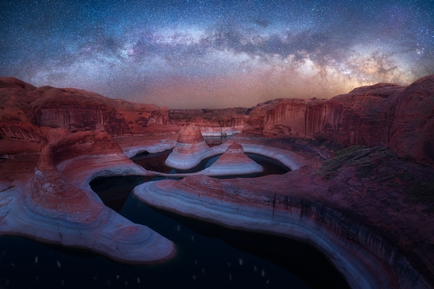 Milky Way arching over the remote Reflection Canyon in Utah 
