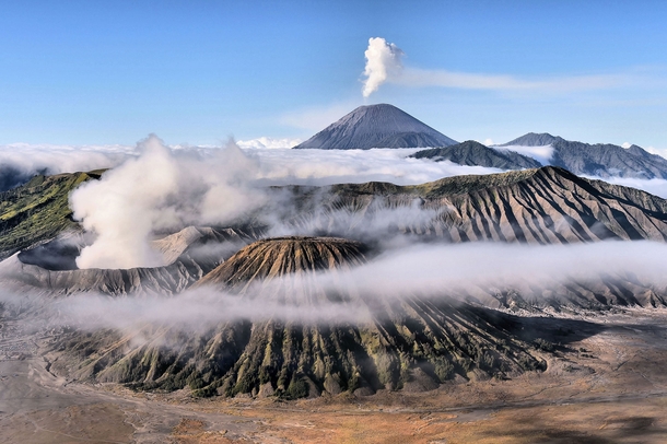 Mount Bromo in foreground and Mount Semeru in background on a misty morning in East Java Indonesia Achmad Sumawijaya 