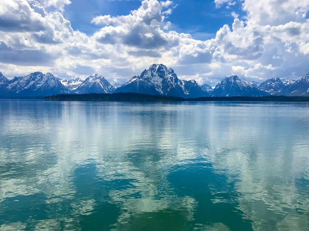 Mountains in Grand Teton National Park reflecting off of a lake  x
