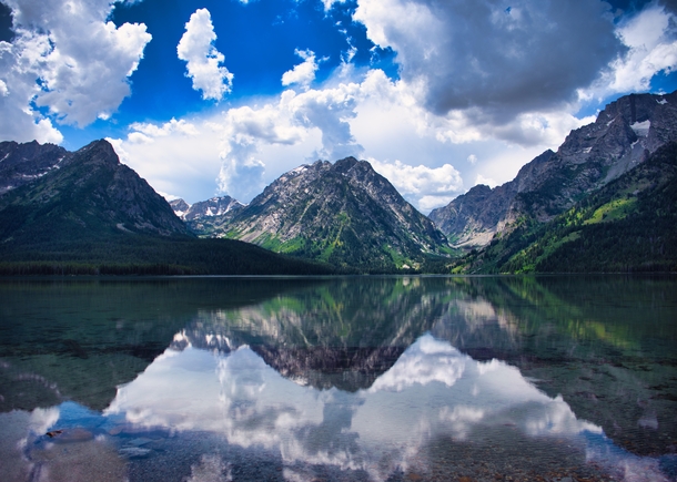 Mountains looming across Leigh Lake in Grand Teton National Park 