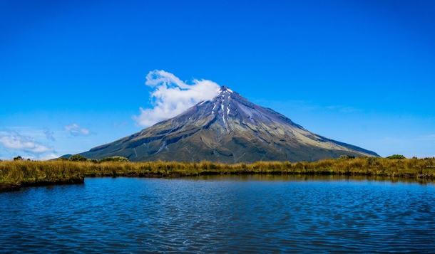 Mt Taranaki one of the most symmetrical volcanos in the world on a clear summer day New Zealand 