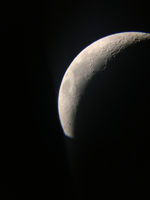 My first attempt at astrophotography- a photo of the crescent moon tonight through my celestron astromaster reflector taken one my phone