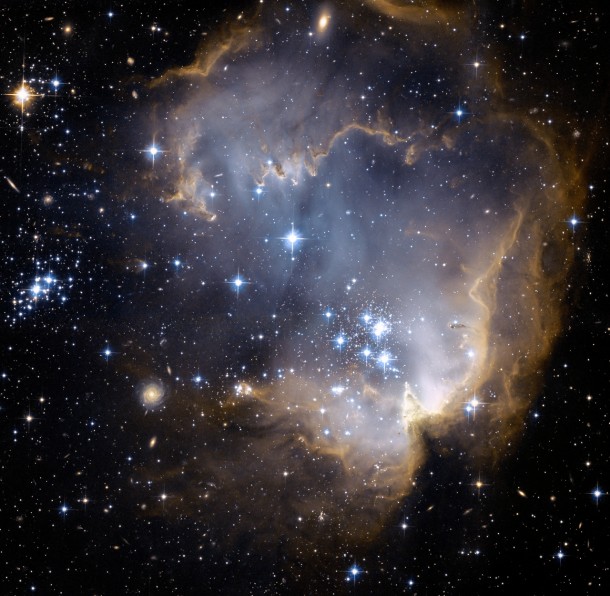 NGC  and Beyond It is only  million years old with massive young stars eroding the dusty material and triggering a progression of star formation 