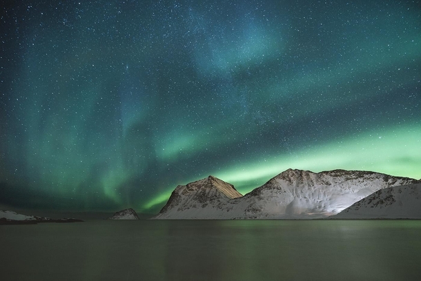 Night sky above one of many Norwegian fjords captured by Simon Migaj OC