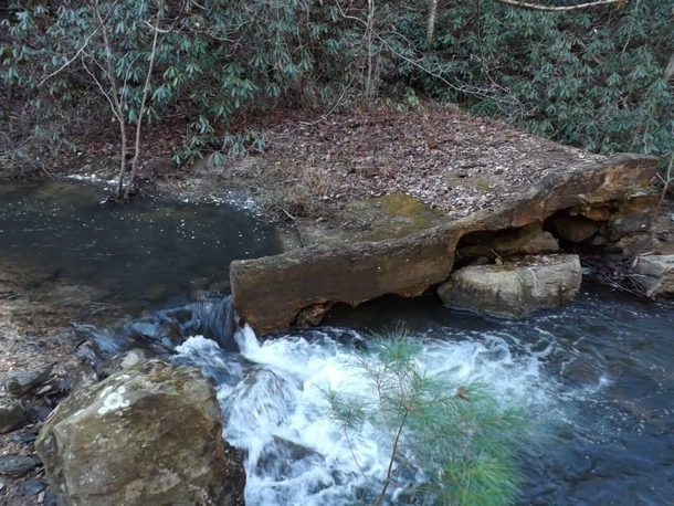 Not much is known about the ruins downstream from Towee Falls According to locals a man looking to generate his own electricity built a mill dam on top of the waterfall For reasons unknown he never saw to the completion of his project Monroe County Tennes