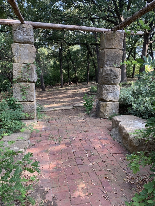 Not totally abandoned but in the process of being forgotten This is a memorial garden in Denison TX The hospital that erected it was moved and the old hospital torn down The stone columns and brick have significance And the grapevines are gone and creek d