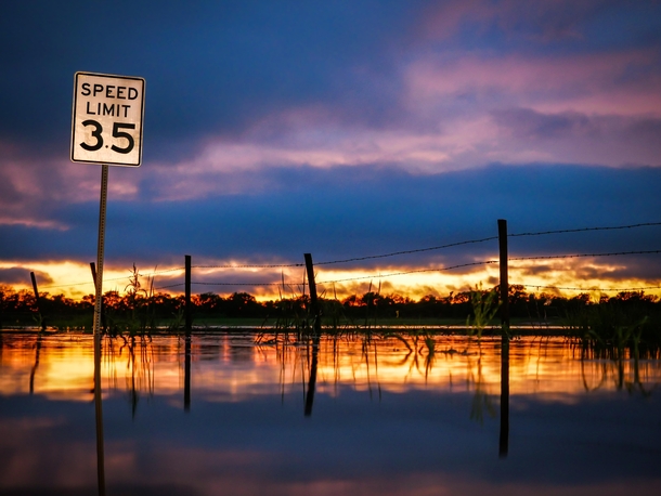 Oklahoma sunset after rains flooded a back road - 