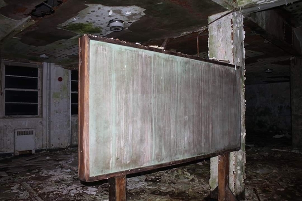 Old decayed chaulk board inside of a boys boarding school
