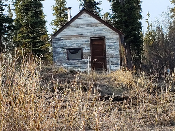 Old RCMP cabin km west of Inuvik NT Canada ft by ft  bunk with  gallon fuel drum for fireplace