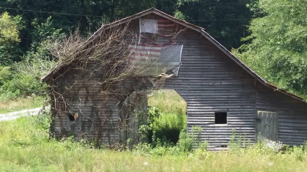 On a visit through Winder GA and saw this abandoned barn Not sure why the bottom flag was positioned this way At first I thought it was the distress signal but thats only if the flag is displayed upside down