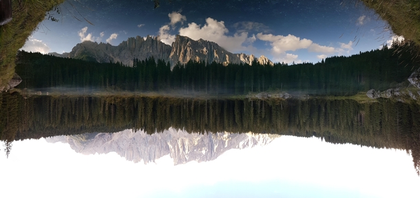 Panoramic Reflection of the Latemar range in the Carezza Lake South Tyrol Italy one month before October  storm 