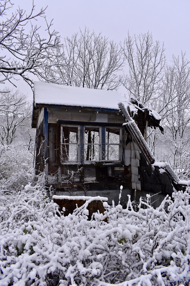 Part of a burnedabandoned house covered in fresh snow just outside Hillsdale NY