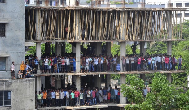 People gather in a neighboring under-construction building to watch the rescue operation of the collapsed Rana Plaza building  km  miles outside Dhaka on April   ReutersStringer 