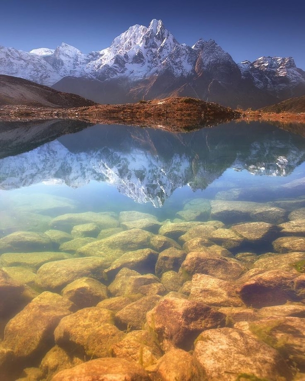 Phungi peak m reflecting on Bimtang lake  m Nepal by Anton Jankovoy 