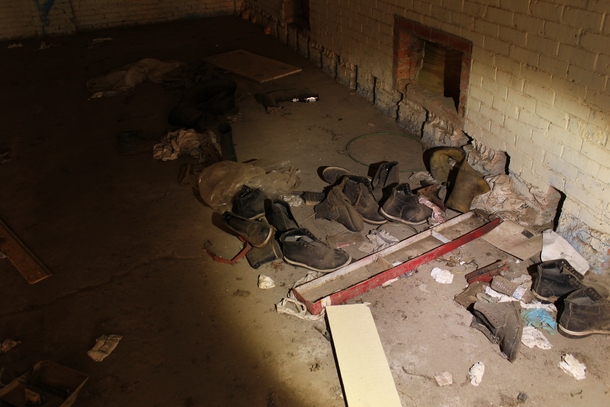 Pile of boots mysteriously left in the distribution center of an abandoned prison 