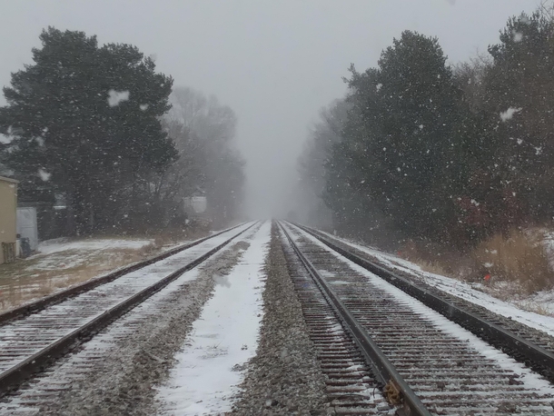 Railroad tracks on a foggy snowy day  Michigan 