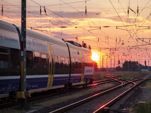 Railroad train amp catenary in sunset 