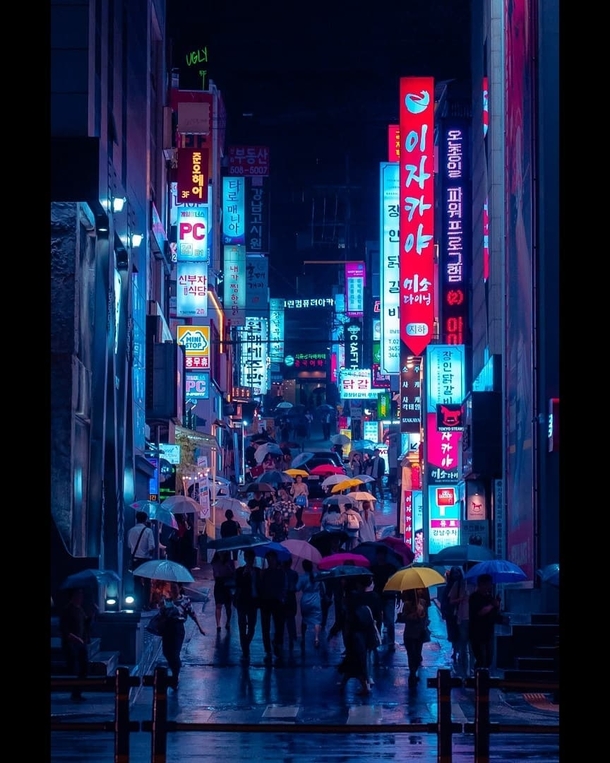 Rain drenched street at night full of umbrellas Gangnam District Seoul South Korea 