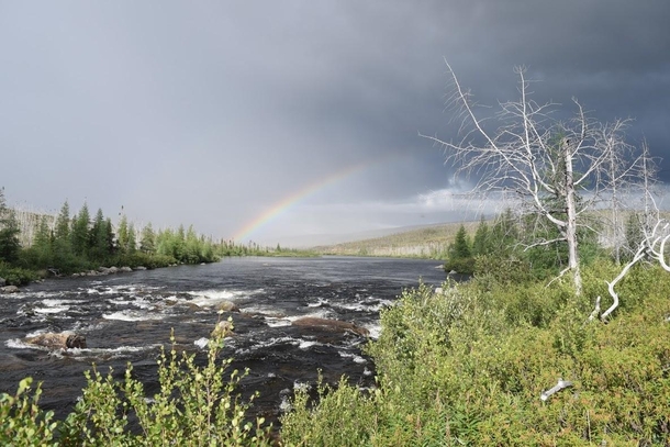 Rainbow peaking out of thunderstorm Labrador Canada 