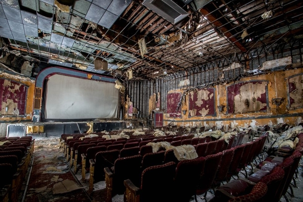 Red tattered seats still occupy this former movie theater