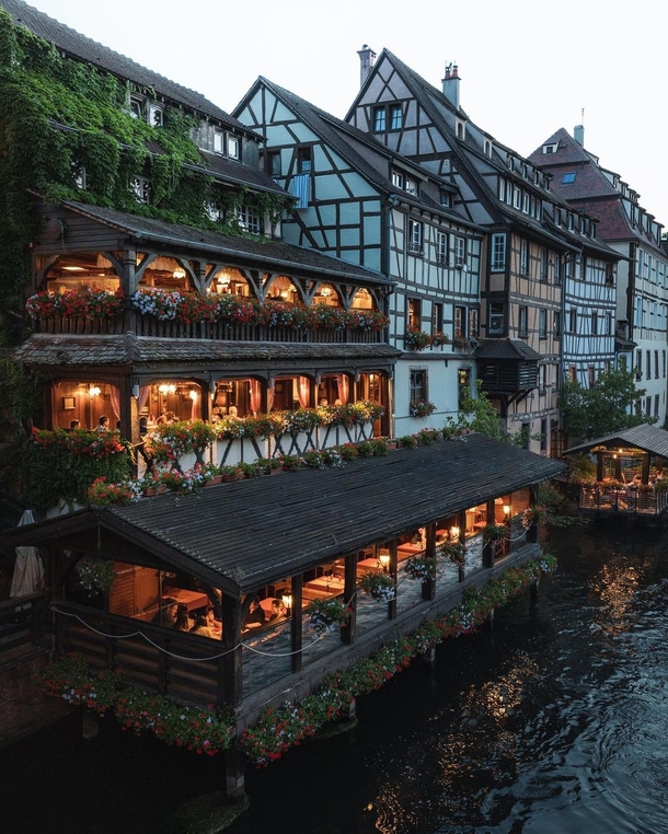 Restaurant on the River Ill flowing through the historic Petite France quarter of Strasbourg France