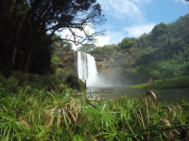 Rewarding view of Wailua falls Kauai Hawaii after a treacherous hike down 