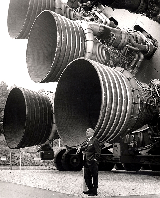 Rocket engineer Wernher von Braun in front of his Saturn V engine 